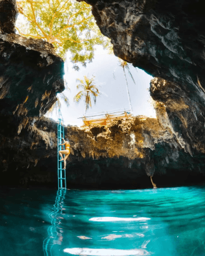 A photo of tourists exporing the sink hole pool in Anda
