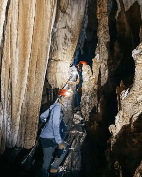 A photo of tourist exploring the cave of Kamira