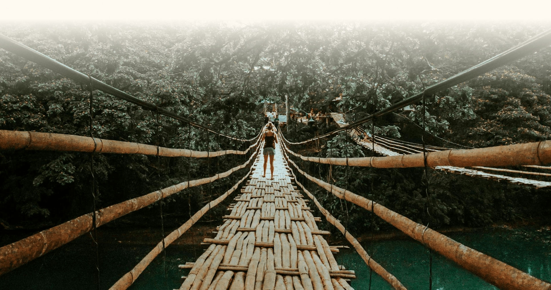 A tourist crossing the Loboc Bamboo Hanging Bridge.
