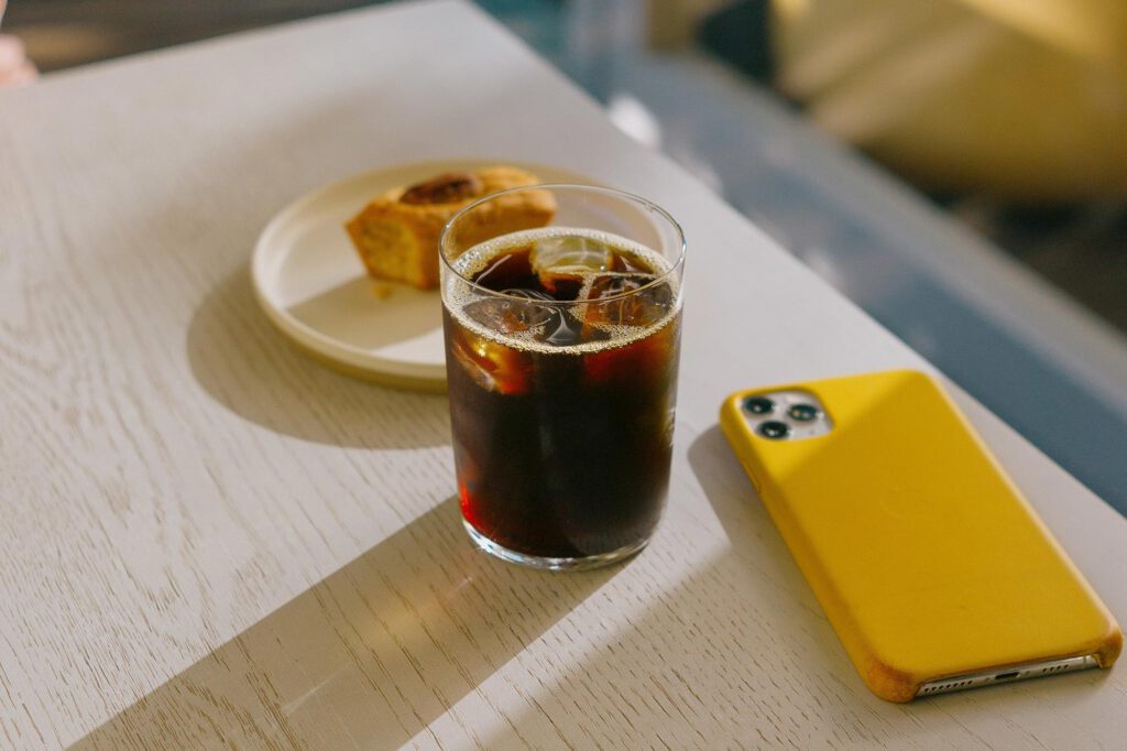 Food and drinks and a phone on a table