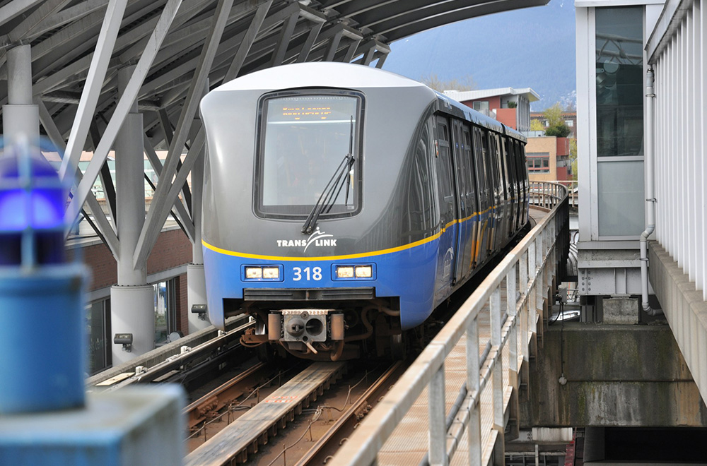 A Vancouver SkyTrain train travelling along an elevated guideway